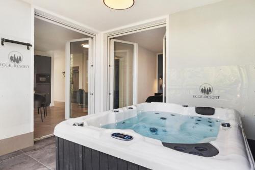 a jacuzzi tub in the middle of a room at Egge Resort 7e mit Whirpool u Sauna in Altenbeken