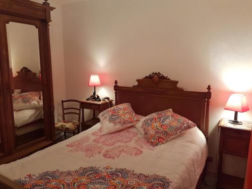 a bedroom with a bed with two pillows and a mirror at Le Nid Marin - 76 in Pornic