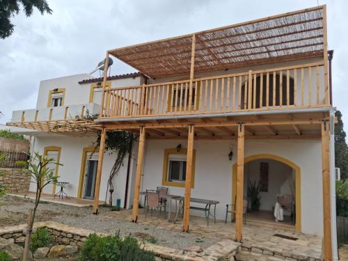 a house with a deck and a patio at Palatinos II in Pitsidia