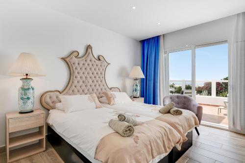 a bedroom with a large bed with a large window at Garden Apartment in Tías