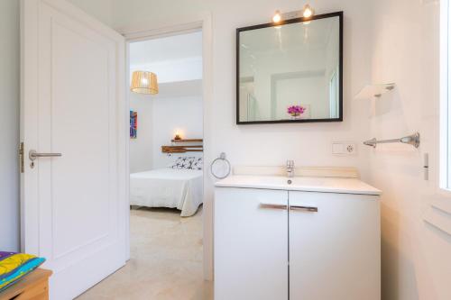 a bathroom with a sink and a mirror on the wall at Na Pallissera in Santanyi