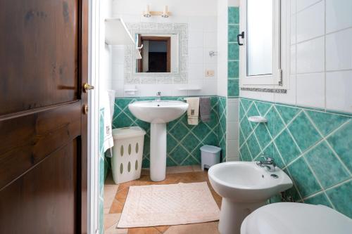 a bathroom with a sink and a toilet at Appartamento da Manzela 2 in Cala Gonone