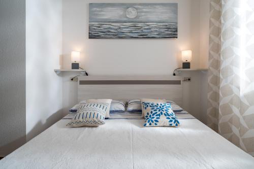 a bedroom with a bed with two pillows on it at Appartamento da Manzela 2 in Cala Gonone