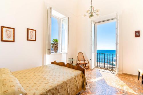 a bedroom with a bed and a view of the ocean at Villa Ramirez in Leuca