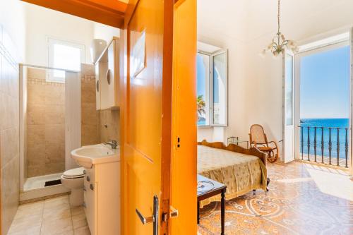 a bedroom with a bed and a sink and a bathroom at Villa Ramirez in Leuca