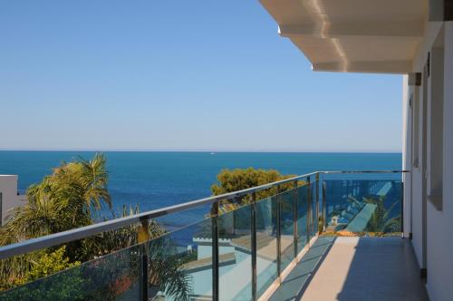 a balcony with a view of the ocean at Apartamentos Bravosol in Denia