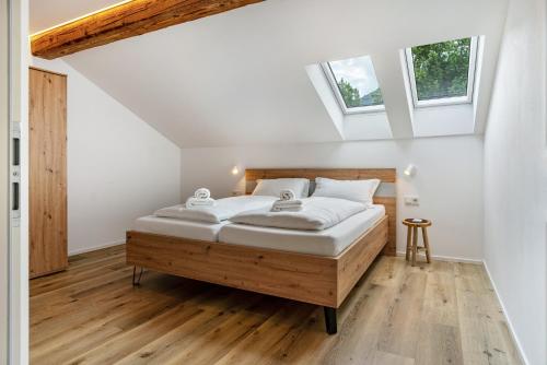 a bedroom with a bed and two windows at Richard´s Home Auer in Auer