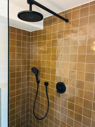 a shower with a shower head in a bathroom at Between hills and home in Trooz