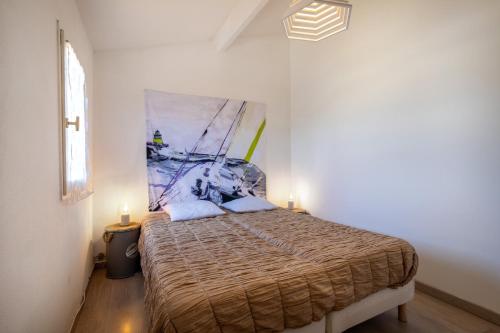 a bedroom with a bed with two candles on it at Maison 4 chambres fb112 in Le Barcarès