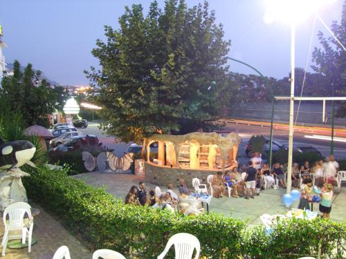 a group of people sitting in chairs in a park at Hotel La Carruba in Cetraro