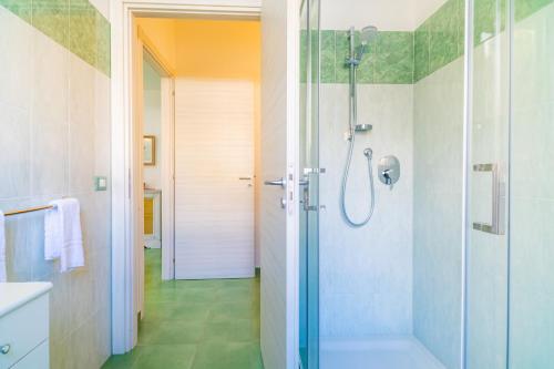 a bathroom with a shower with a glass door at Casa Orchidea in Calatabiano