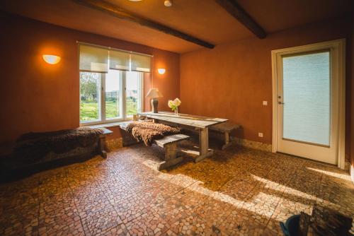 a room with a table and a bench and a window at Karu Holiday Home in Laiusevälja