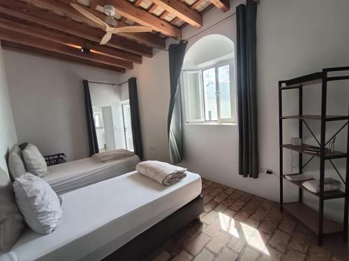 a bedroom with a large bed and a mirror at Casa Privada in Vejer de la Frontera