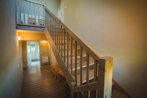a wooden staircase in a house with a stair case at Karu Holiday Home in Laiusevälja
