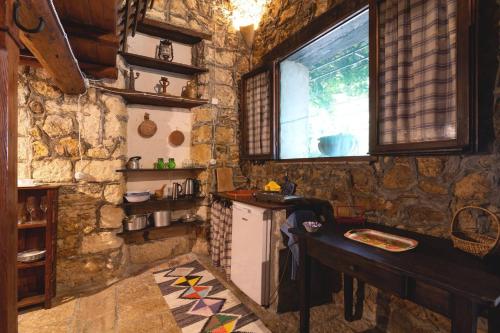 a stone kitchen with a counter and a window at Tenuta Donna Vittoria in Trapani