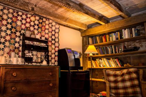 a room with a dresser and book shelves with books at Windham Hill Inn in West Townshend