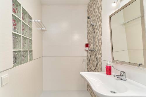 a white bathroom with a sink and a mirror at Nerja Boutique B2 Street level in Nerja