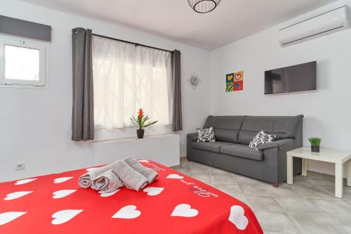 a living room with a bed and a couch at Nerja Boutique B2 Street level in Nerja