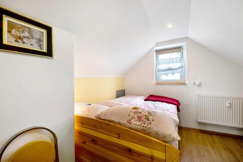 a bedroom with a bed and a window at Picco 1 in Beuren