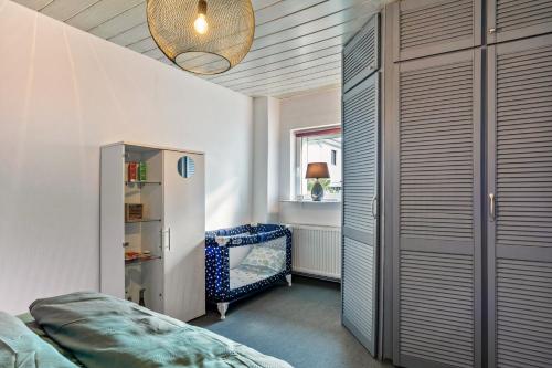 a bedroom with a bed and a chair and a window at Kleines Haus in Bernau bei Berlin