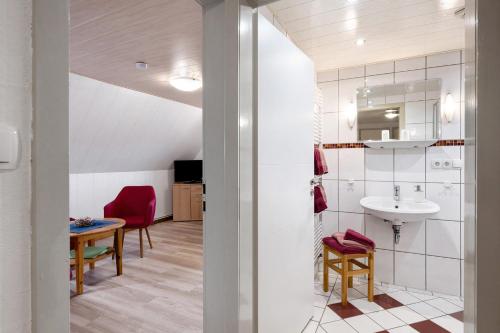 a bathroom with a sink and a table at Bauernhof Angelika Schulze Pellworm in Pellworm