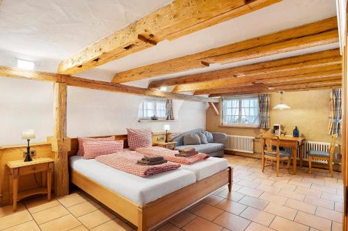 a bedroom with a bed and a living room at Holzwurm Apartments in Sasbachwalden