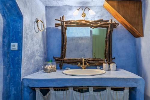 a bathroom with a sink and a mirror at Olive Guesthouse near farm in Fállika