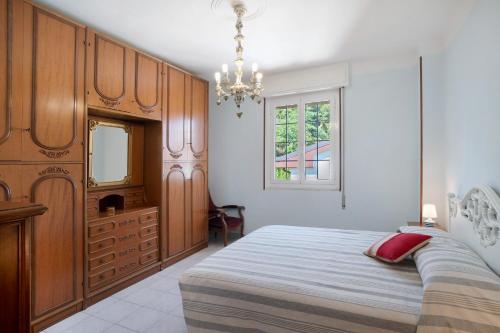 a bedroom with a bed and a dresser and a mirror at La Ca' Di Marì in Costarainera