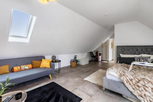 a bedroom with a bed and a couch at Deluxe Apartment in Duisburg