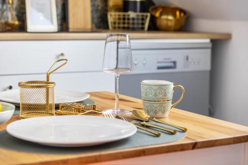 a table with a plate and a glass of wine at Deluxe Apartment in Duisburg