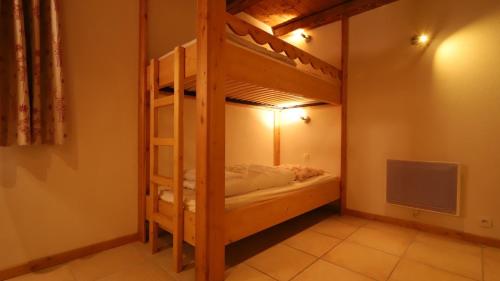 a bunk bed in a room with a television at Chalet Alpaga 6 in Bonneval-sur-Arc
