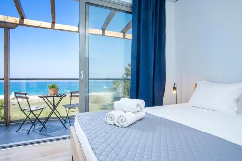 a bedroom with a bed and a large window at Rhodes Sea Villas No 2 in Ialysos