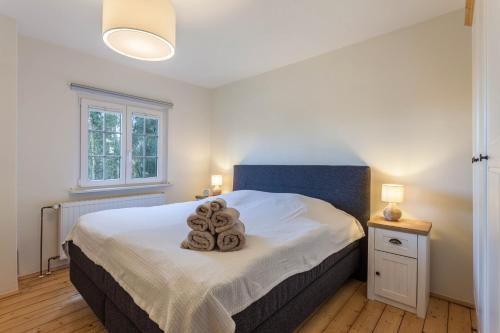 a bedroom with a bed with two towels on it at Homertstuebchen in Eslohe