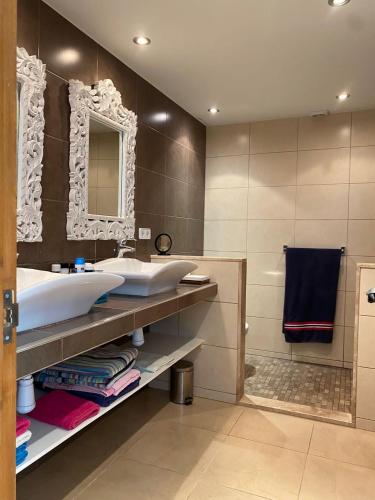 a bathroom with two sinks and a mirror at Villa Francisco in Calonge