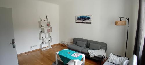 a living room with a couch and a table at Fewo Nied in Rehlingen-Siersburg