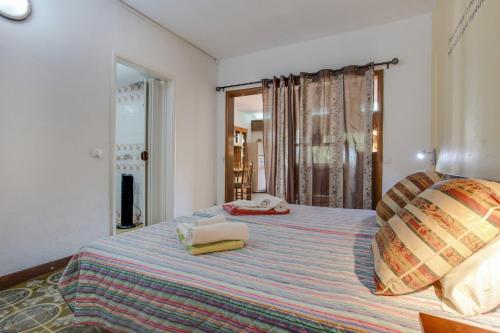 a bedroom with a bed with two towels on it at Studio with Private Garden in Lagos