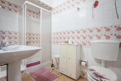 a bathroom with a sink and a toilet at Studio with Private Garden in Lagos