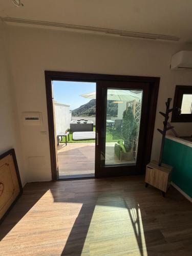 a room with a door open to a patio at Sardinia house with beautiful view near sea in Brunella
