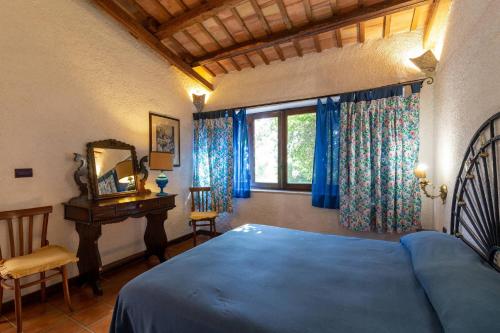 a bedroom with a blue bed and a window at Tenuta Donna Vittoria in Trapani