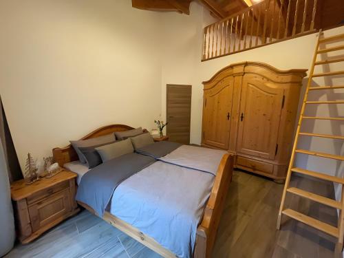 a bedroom with a bed and a ladder in it at Ferien-Schindeldorf in Stromberg