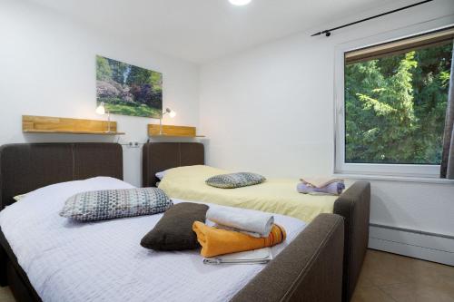 two twin beds in a room with a window at Ferienanlage in Großkoschen