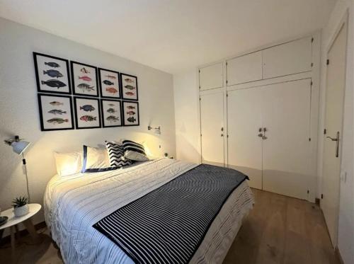 a bedroom with a large bed and a table at Eden Mar Calonge Girona in Calonge