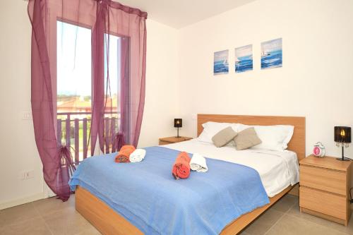a bedroom with two beds and a window at New Casa Augusto in Lazise