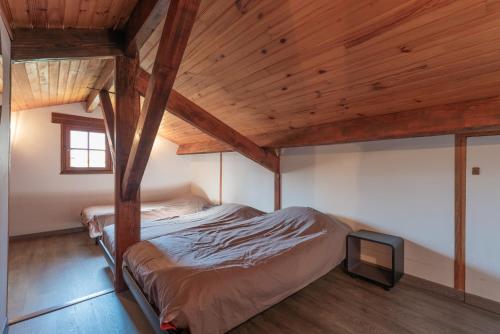 an attic bedroom with a bed and a tv at Domaine de l'Arbizon in Bagnères-de-Bigorre