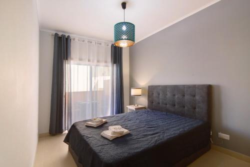 a bedroom with a bed with two towels on it at Royal Cabanas Golf 85 in Cabanas de Tavira