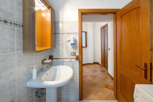 a bathroom with a sink and a mirror at Residence Malibu Appartamento 7 in Falcade