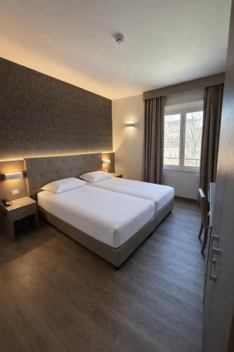 a hotel room with a large bed and a window at LVG Hotel Collection - Principe in Modena
