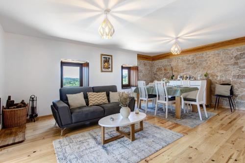 a living room with a couch and a table at Casa Do Pião - Turismo Rural in Ancião