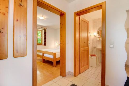 a hallway with a door leading to a bedroom at Schwarzbauernhof in Eschlkam