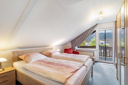 a bedroom with two beds and a large window at Haus Erika in Stryck